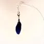 Preview: Detailansicht der blauen Feder (6x2 cm) als Kettenanhänger an einem eleganten Bettelarmband.