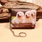 Preview: Weißer kleiner Geldbeutel mit Fotodruck von zwei Golden Retriever Welpen in Eimern, inklusive Gliederkette und Schlüsselring.