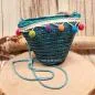 Preview: Kleine runde Korbtasche für Kinder aus natürlichem Rattan mit langer Kordel-Schulterband.
