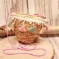 Preview: Kleine runde Korbtasche für Kinder aus naturfarbenem Rattan mit bunten Pastell-Quasten und Kordel-Schulterband.