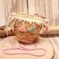 Preview: Kleine runde Korbtasche für Kinder aus naturfarbenem Rattan mit bunten Pastell-Quasten und Kordel-Schulterband.