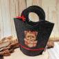 Preview: Handgenähte schwarze Kindertasche aus Filz mit gepresstem Hundemotiv, runden Griffen und kleiner Schleife der Marke weidräwöl.