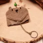 Preview: Gehäkelter Schlüsselanhänger Bär handmade in Grau mit grüner Perle als Taschenbaumler für den Online-Shop