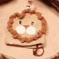 Preview: Gehäkelter Schlüsselanhänger Löwe handmade in Beige und Braun mit hellblauer Perle als Taschenbaumler