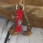 Preview: Schlüsselanhänger aus Filz mit aufgenähtem Metall-Edelweiß rot