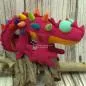 Preview: Stofftier Dinosaurier in rot-pink mit bunten Stacheln
