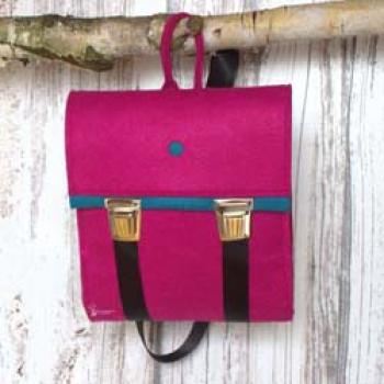 Kleiner pinker Rucksack aus Filz mit türkisfarbenem Innenleben und verstellbaren Trägern im Detail.