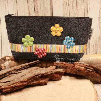 Handgenähte weidräwöl Kosmetiktasche aus dunkelgrauem Filz mit Blumen und bunter Streifenbordüre.