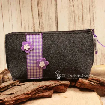 Handgenähte dunkelgraue Filz Kosmetiktasche mit lila Karoband und Blumen-Applikationen.