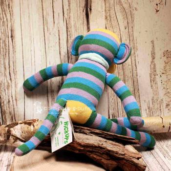 Mittlerer Affe als Stofftier mit bunten Streifen