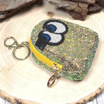 Gelbes Glitzer-Schlüsselmäppchen mit Augen-Motiv, geschlossen, frontal.
