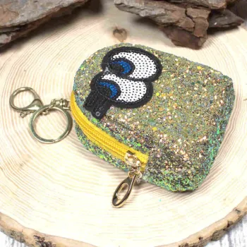 Gelbes Glitzer-Schlüsselmäppchen mit Augen-Motiv, geschlossen, frontal.