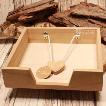 Rustikaler Serviettenständer aus hellbraunem Holz mit gut sichtbarer Holzstruktur und Griffaussparung.