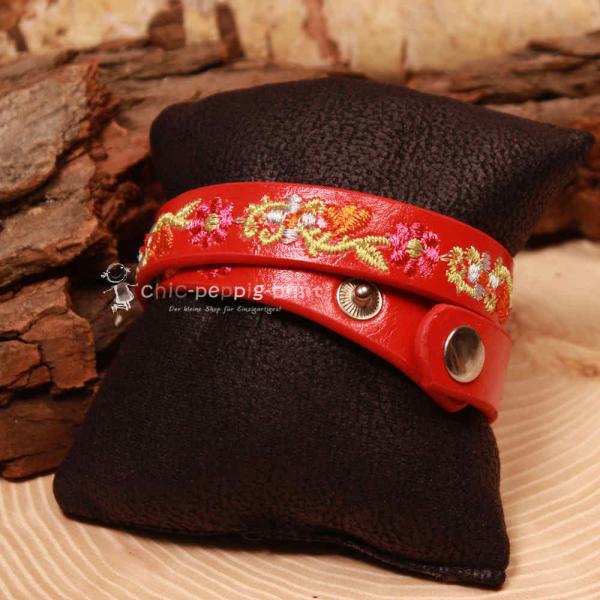 Zwei silberne Druckknöpfe zur Längenverstellung am 40 cm langen roten Trachtenaccessoire.