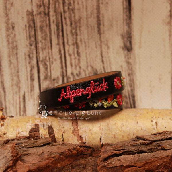 Zwei silberne Druckknöpfe zur Längenverstellung am 40 cm langen schwarzen Trachtenaccessoire.