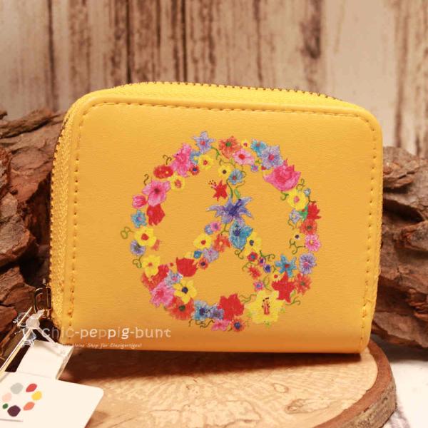 Kleiner Geldbeutel aus Kunstleder mit Peace-Zeichen und Blumen sowie umlaufendem Reißverschluss.