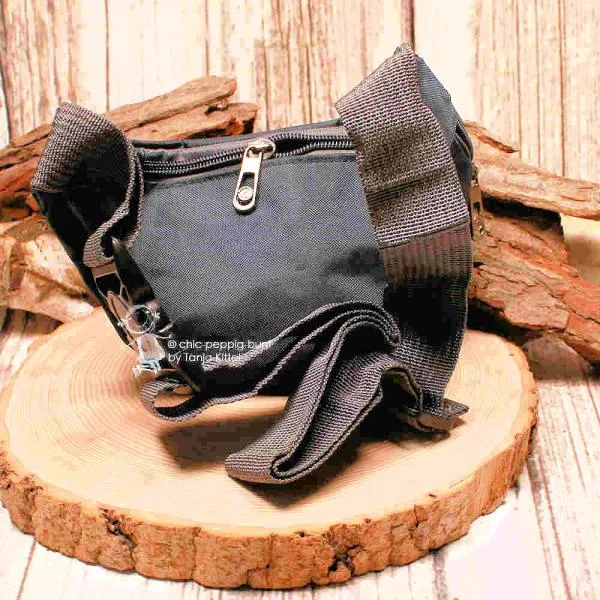 Schräge Detailaufnahme der Bauchtasche zur Veranschaulichung der beiden vorderen Reißverschlussfächer.