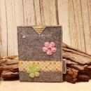 Handgenähte hellgraue Filz Passhülle der Marke Weidräwöl mit zwei karierten Blumen und einer Bordüre mit bunten Punkten für Ausweise.